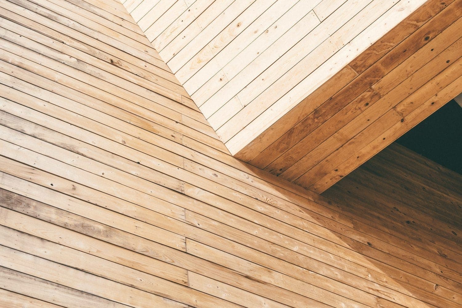 Pale wooden planks meeting at an angle